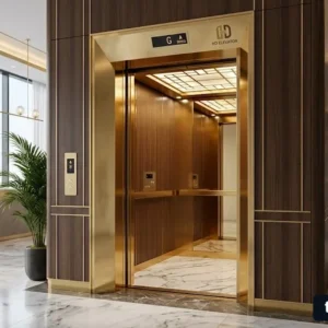 Mẫu thang máy khách sạn 800kg sang trọng với thiết kế inox gương vàng và sàn đá cao cấp.
