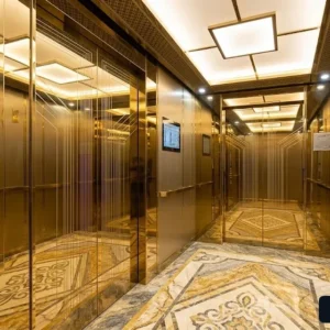 Báo giá lắp đặt thang máy tòa nhà văn phòng với vật liệu cabin inox gương vàng sang trọng.